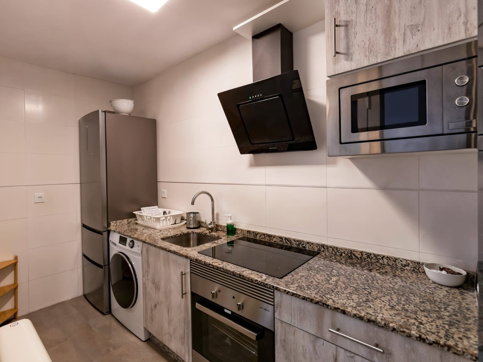 Fitted kitchen of an apartment at Nova MSuites Catedrales